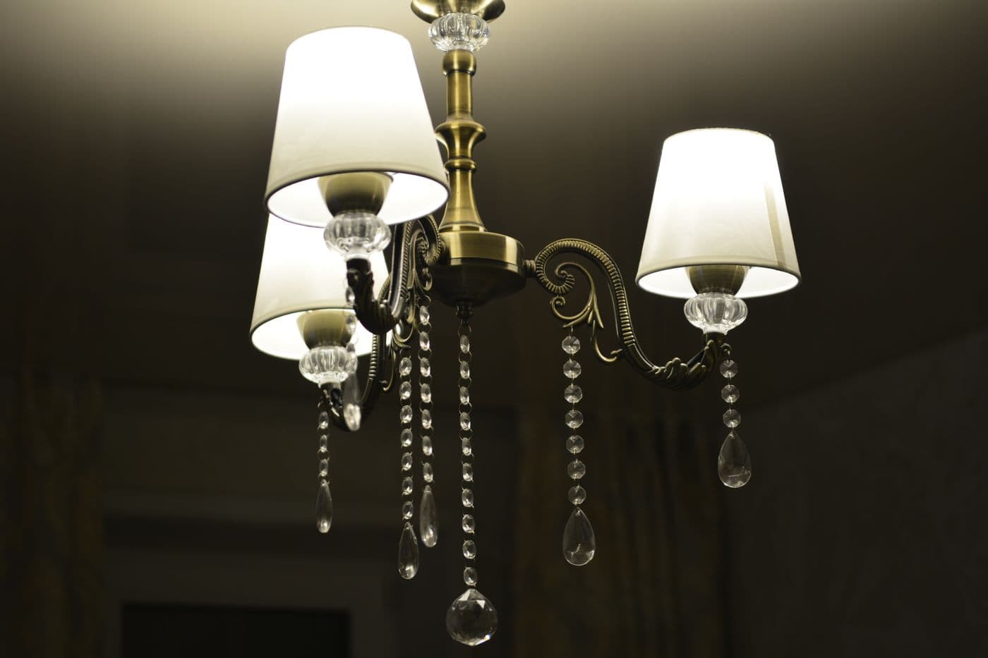 Brass chandelier with crystal accents glowing indoors