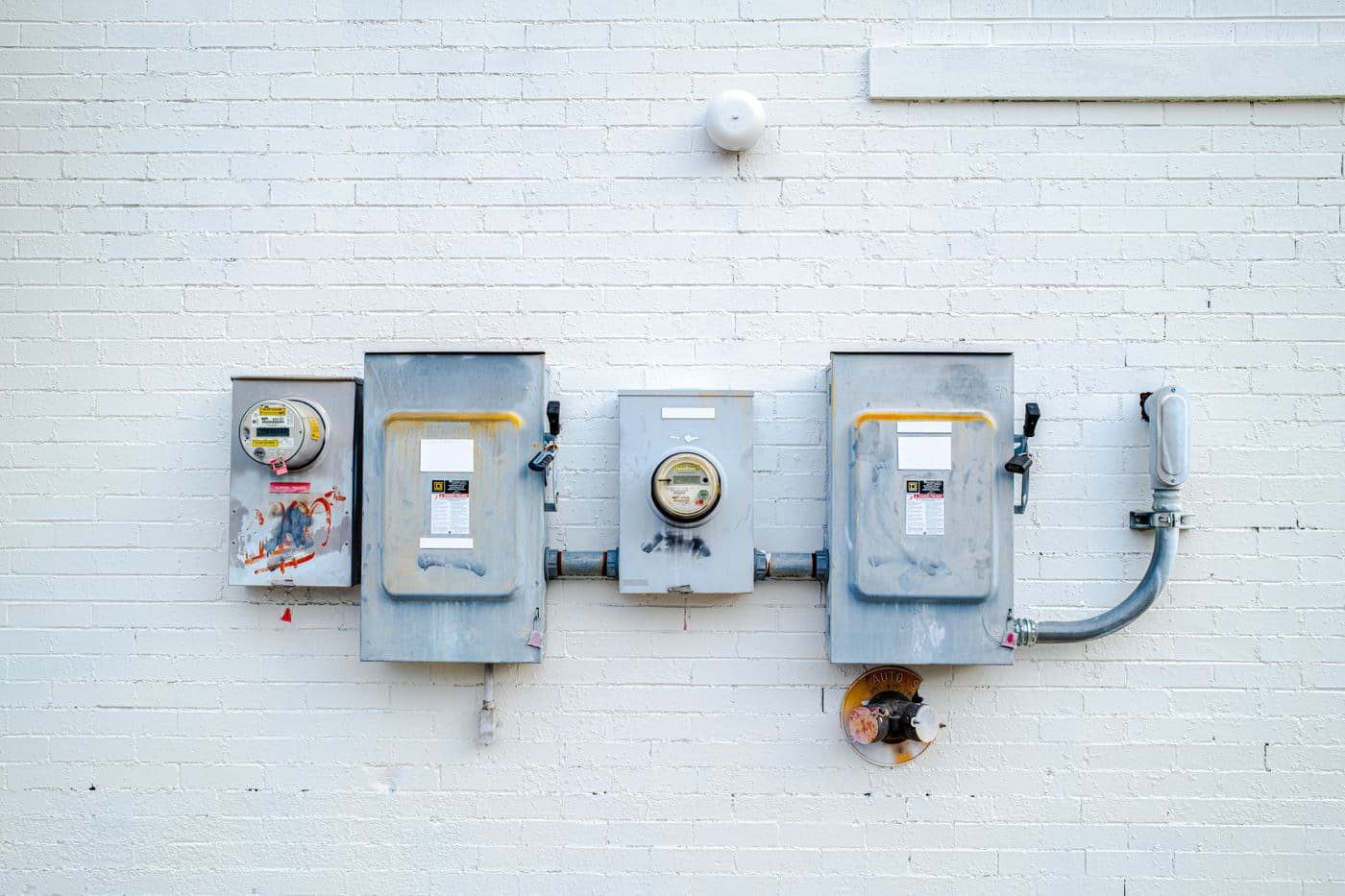 Electrical boxes and power meters mounted on a wall
